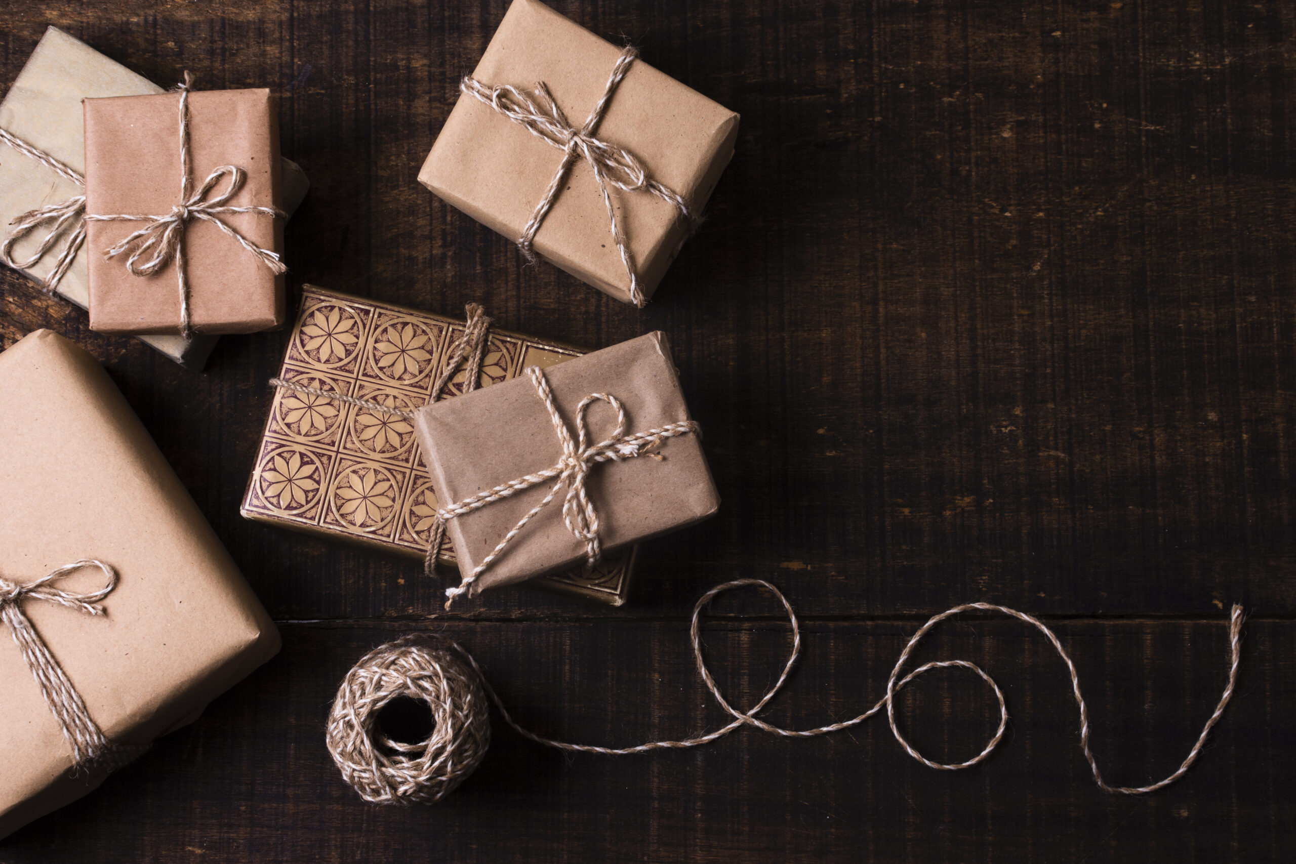 gifts-wrapped-paper-with-wooden-background The Boardroom Edition